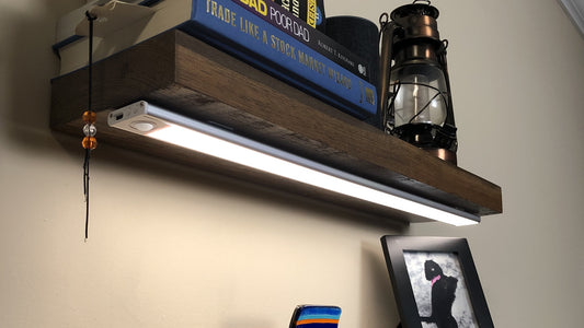 Magnetic motion sensor LED strip light illuminating shelf